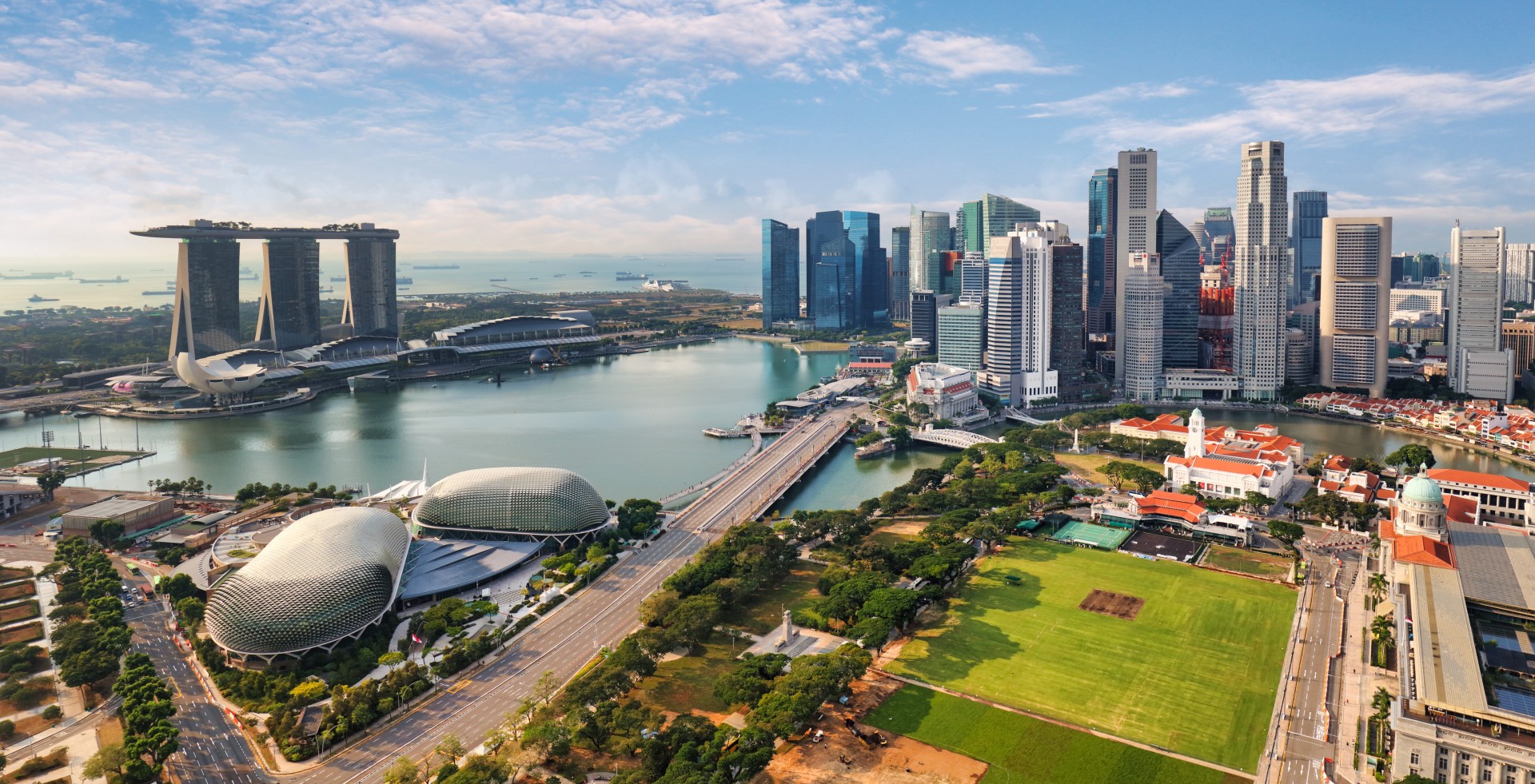 Aerial view of Singapore’s Marina Bay area featuring Marina Bay Sands, the Esplanade Theatres, and the modern skyline of the Central Business District.