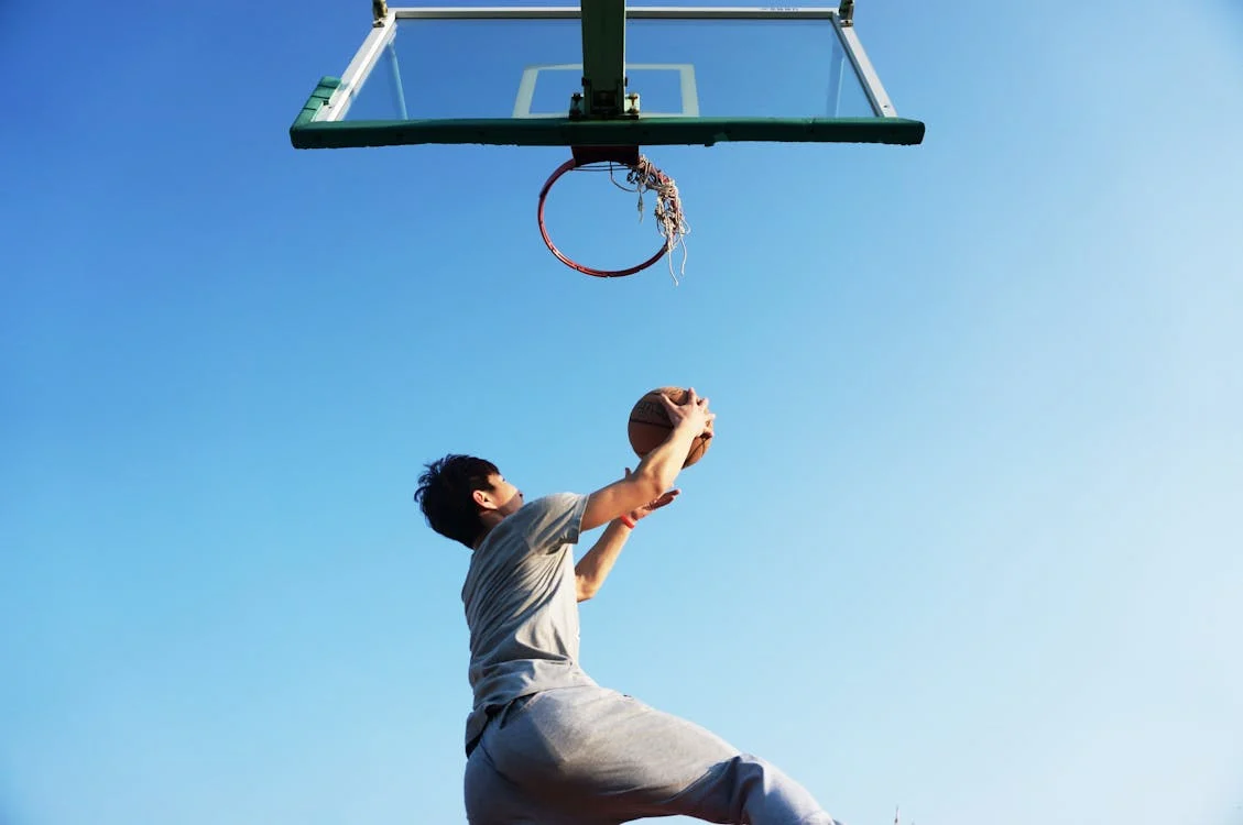 A person dunking a basketball