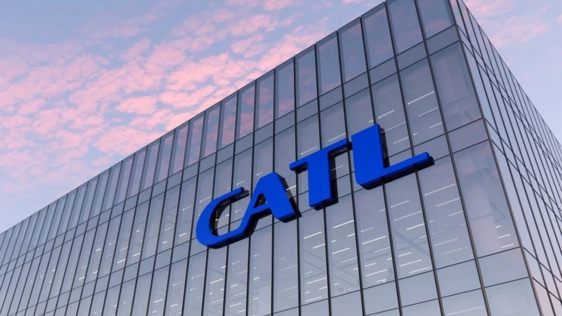 Exterior of CATL corporate headquarters with large blue logo on a modern glass building, set against a pastel pink and blue sky at sunset.