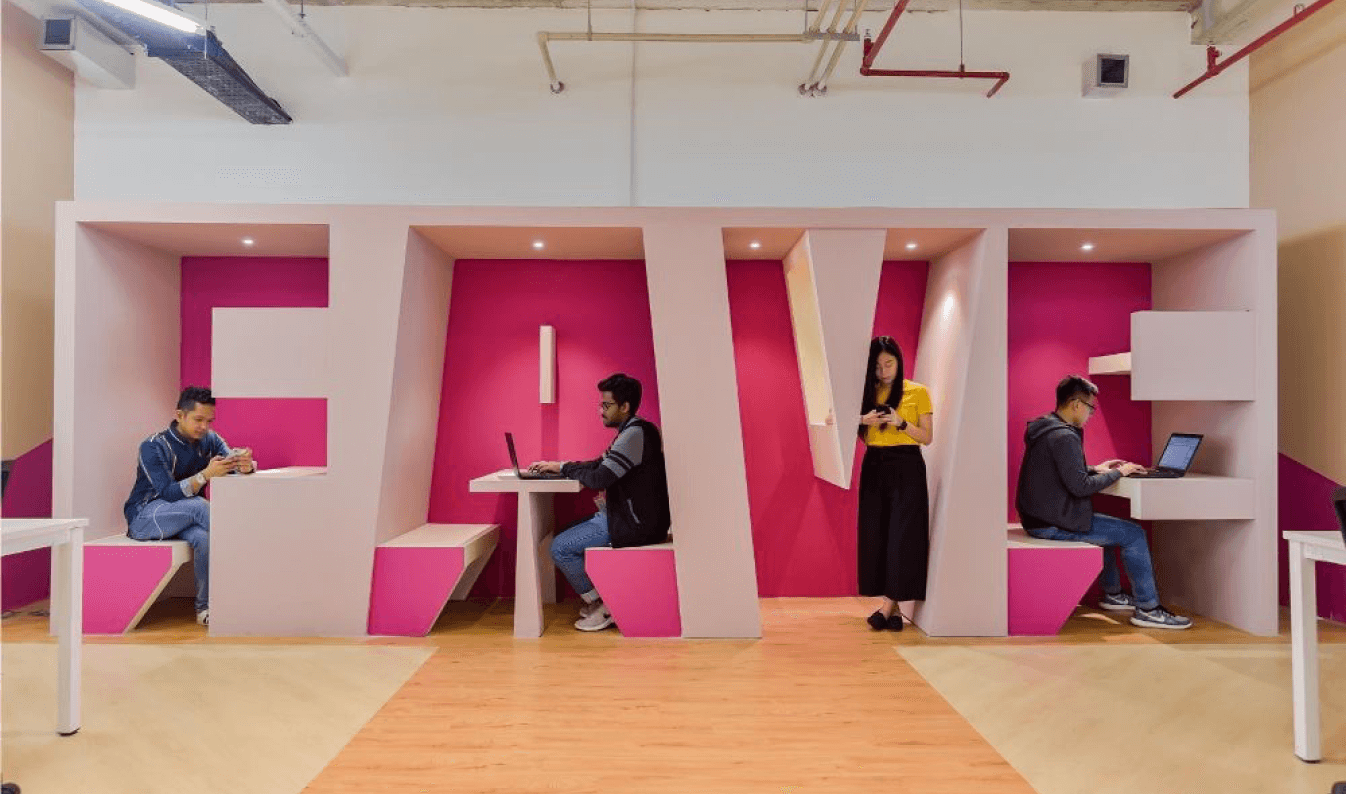 Creative workspace at Fave office with pink booths shaped as company name letters.